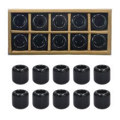 twelve black ceramic knobs in a wooden box and eight black plastic knobs on each side