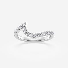 a white gold wedding ring with diamonds on the band and an arrow shaped design in the middle