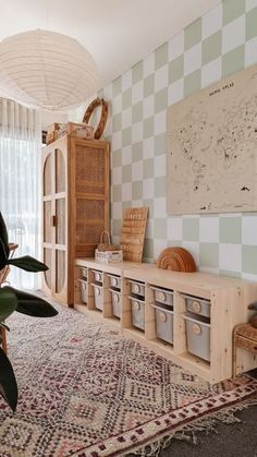 a living room filled with lots of furniture next to a wall mounted art piece on top of a wooden shelf