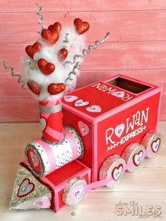 a valentine's day train made out of toilet paper and tinsel with hearts on it