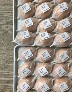 several trays filled with chicken wrapped in plastic wrappers and labeled with labels on them