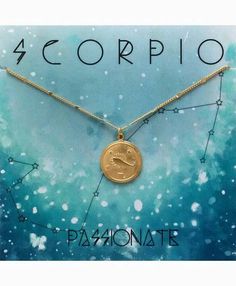 the zodiac sign is displayed on a gold plated necklace with an aqua blue background