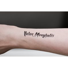 a person with a tattoo on their arm that says valar morghulis