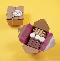 two boxes with different types of chocolates in them on a yellow background, one is open and the other is closed