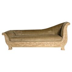 an antique style chaise lounge with carved details