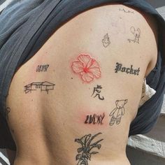 the back of a woman's shoulder with tattoos on it