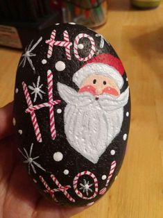 hand painted rock with santa clause and candy canes