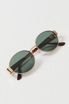 A classic oval frame for a sleek, timeless look. **Features:** Round frames, metal rims, metal nose bridge, adjustable nose pads, thin temples, gripped ends, tinted lenses **Why We | Little Secret Round Sunglasses by Free People in Gold Timeless Sunglasses Women, Cute Sunnies, Women’s Sunglasses, Wire Sunglasses, Aesthetic Sunglasses, Glasses Styles, 90s Sunglasses, Circle Sunglasses, Gold Glasses