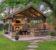 an outdoor kitchen and grill area in the backyard