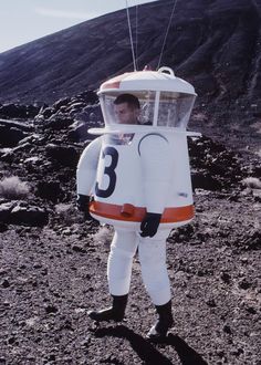 a man in an astronaut suit is holding a sign that says original on the side