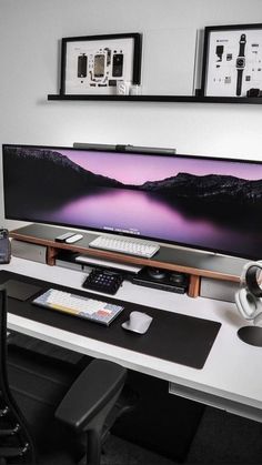 a flat screen tv sitting on top of a white desk