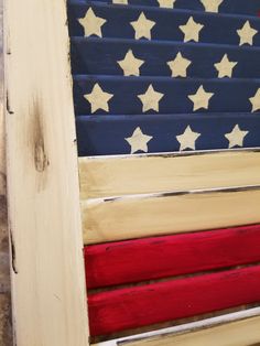 an american flag painted on the side of a wooden door with red, white and blue stars