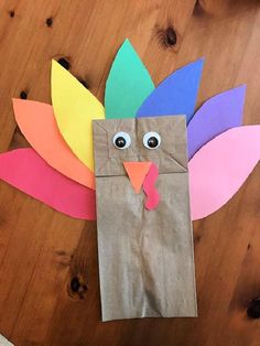 a paper bag with a turkey made out of it on top of a wooden table