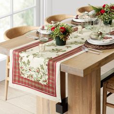 the table is set with place settings and flowers