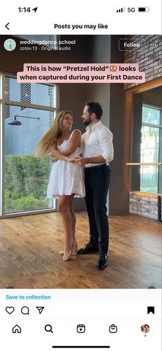 a man standing next to a woman on top of a wooden floor in front of a window