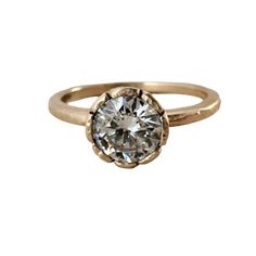 A testament to the enduring power of nature's love, this exquisite engagement ring is a delicate masterpiece. This round lab diamond, a symbol of eternal beauty, sits nestled in a unique bezel setting that evokes the graceful petals of a wildflower in full bloom. Its organic shape and gentle curves capture the essence of nature's untamed spirit, while the diamond's brilliance reflects the radiant warmth of the sun. This is more than just a ring; it's a promise of a love as enduring and beautiful as the natural world itself. Details: Material: 14K Yellow Gold Gemstone: 1.0 CTRound Harmony Lab Grown Diamond E VVS2 6.5mm IGI Report Number Dimensions: 1.5mm wide band with light hammered texture Polished Finish Ring Size 7 is ready to ship Current turnaround time 3-4 weeks. All jewelry is made- Fine Jewelry Flower Ring With Rose Cut Diamonds, Luxury Yellow Gold Flower Ring With Rose Cut Diamonds, Luxury Rose Cut Diamond Flower Ring, Luxury Rose Cut Diamond Nature-inspired Rings, Luxury Yellow Gold Nature-inspired Flower Ring, Velvet Ring Box, Yellow Jewelry, Round Diamond Ring, Knot Earrings