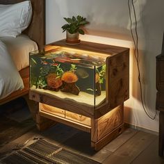 a fish tank sitting on top of a wooden table next to a bed and nightstand