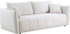 a white couch with four pillows on it's back and two sides facing each other