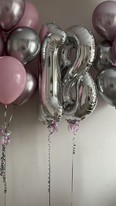 balloons and streamers in the shape of the number twenty eight are displayed against a wall