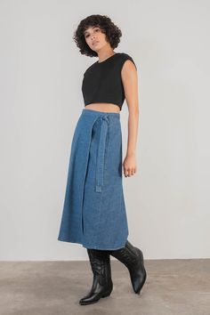 Denim by Nature™ Look effortless in a midi Evelyn wrap skirt. Take inspo from the coastal cowgirl trend by pairing this aline midi skirt with cowboy boots and a crop top. Evelyn is crafted in our innovative Denim by Nature™ biodegradable hemp cotton stretch denim that has a soft drape. Made from hemp, cotton, bamboo (cellulose fiber) and biodegradable polyester. Will revert back to nature at the end of their life cycle. Hemp is a natural fiber that is grown and cultivated with minimal impact on Wrap Denim Skirt, Skirt With Cowboy Boots, Aline Midi Skirt, Cowgirl Skirt, Denim Wrap Skirt, Cellulose Fiber, Denim Outerwear, Aesthetic Women, Coastal Cowgirl