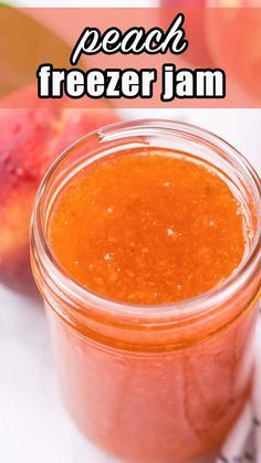 peach freezer jam in a glass jar next to sliced peaches