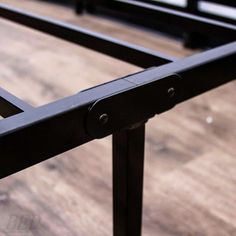 a close up of a metal bed frame on a wooden floor