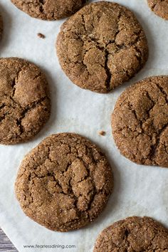 chocolate cookies are lined up on top of parchment paper, ready to be baked in the oven