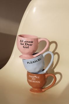 three coffee mugs stacked on top of each other with the words present for dear girl