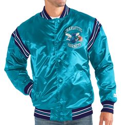 a man wearing a blue satin jacket with the charlotte hornets on it's chest