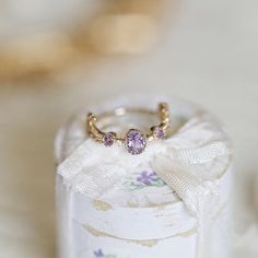 Description: Inspired by the enchanting landscapes of Provence, this delicate ring showcases a stunning amethyst gemstone set in a romantic, vintage-inspired design. The 18k gold-plated setting adds a touch of luxury and durability, making it a perfect accessory for any occasion. Product Details: -Amethyst -925 Silver base -18K Gold plated -Adjustable size Measurement: 3/4" diameter. Elegant Lavender Amethyst Ring In 14k Gold, Elegant Amethyst Birthstone Crystal Ring, Exquisite Gold Amethyst Ring With Gemstone Accents, Elegant Amethyst Crystal Ring With Gemstone Accents, Elegant Purple Amethyst Open Ring, Elegant Yellow Gold Amethyst Open Ring, Elegant Lavender Crystal Ring, Lavender 14k Gold Rings Fine Jewelry, Exquisite Gold Amethyst Ring