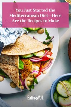 a white plate topped with a pita filled with veggies