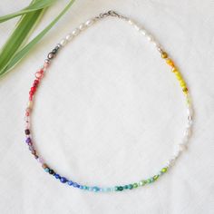 Rainbow beaded necklace is a beautiful colorful necklace with a huge selection of different kinds of beads. In this silver-plated necklace, there are genuine freshwater pearls in different shapes, sizes and colors, glass beads (seed beads, crystal glass beads, millefiori etc.), and gemstones. Each necklace is a unique piece made to order - the order and the selection of beads may vary. The length of the necklace is 16.5 inches (42 cm). Let me know if you want another length!  ♥ Jewelry care ♥ It's important to keep your jewelry dry: Take it off before taking a shower, bath, swimming, or exercising. Always apply your makeup, perfume, and hairspray before putting on your jewelry.  Store your jewelry somewhere dry (not in the bathroom). See my whole jewelry collection: https://www.etsy.com/sh Bohemian Multicolor Pearl Necklace With Pearl Charm, Multicolor Bohemian Pearl Necklace With Charm, Bohemian Multicolor Pearl Necklace With Charm, Colorful Pearl Beaded Choker Necklace, Handmade Multicolor Pearl Necklace, Colorful Beads Pearl Choker Necklace, Colorful Beaded Pearl Choker Necklace, Rainbow Round Beads Pearl Necklace, Rainbow Pearl Charm Jewelry