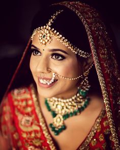 a woman in a bridal outfit looking into the mirror