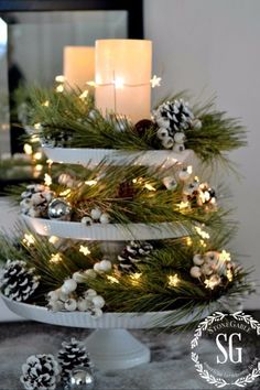 a christmas tree decorated with pine cones and candles