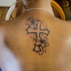 a man with a cross tattoo on his back