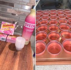 there are many cups on the counter and one is filled with pink liquid next to an oven