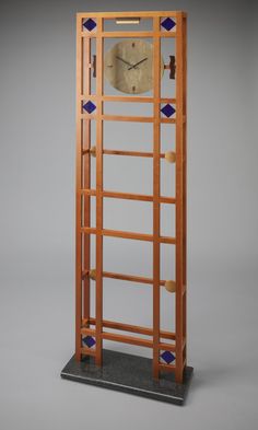 a tall wooden clock sitting on top of a table