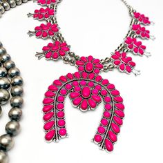 Add an eye-catching pop of color to your wardrobe with the Western Women Squash Blossom Necklace. Crafted in hot pink, it makes a bold statement that is sure to get attention. Its unique design will bring a special edge to your outfits. This necklaces is adjustable up to 25 inches long. SKU: #0618-2339 Bold Pink Jewelry For Gifts, Vibrant Pink Jewelry For Party, Vibrant Pink Jewelry Gift, Vibrant Pink Jewelry For Gift, Western Women, Squash Blossom Necklace, Squash Blossom, In Hot, Unique Design