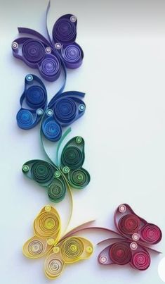 two colorful paper butterflies on a white background