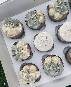 there are many cupcakes that have frosting on them, and one is decorated with flowers