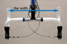 the front end of a bicycle with an arrow pointing to it's bar width