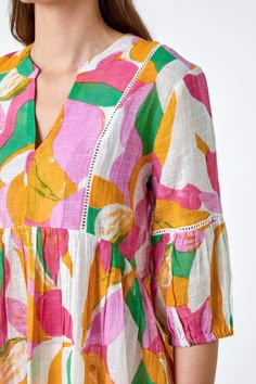 Relaxed fits and colourful prints are the perfect combination for your Summer wardrobe and this tunic top has both in abundance. Cut from a cool, cotton fabric, this piece features a feminine notch neckline and 3/4 length sleeves finished with elasticated cuffs. A relaxed waistline ensures a flattering fit throughout the longline piece. Adorned in a bold abstract print, this smock top also features delicate ladder lace details across the chest and on the sleeves. Add cropped jeans and sandals fo Lace Detail Dress, Cotton Sleeves Design, Elastic Sleeves Design, Ikkat Tops, Cotton Tops For Jeans, Tunic Tops Outfit, Cotton Summer Tops, Baby Dress Embroidery, Cotton Tops Designs