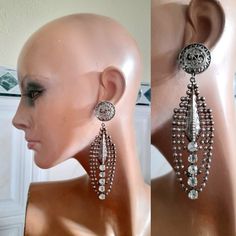 Beautiful vintage oversized silver tone metal, clip on,  oblong dangling earrings. Front clip on part is out of faux filigrane, from where it falls an oval dangling pendant  embellished with strass. Measures: Full length 11cm/4.4" Pendant 8.5cm/3.3" Width: 3cm/1.18" In very good vintage condition. If you have any questions please feel free to contact me, thank you for watching. International and domestic postage signed for with tracking number. Evening Metal Clip-on Chandelier Earrings, Clip-on Metal Chandelier Earrings For Evening, Vintage Metal Chandelier Earrings For Party, Silver Metal Clip-on Earrings For Party, Silver Clip-on Chandelier Earrings For Evening, Glamorous Metal Dangle Clip-on Earrings, Formal Metal Clip-on Chandelier Earrings, Metal Clip-on Chandelier Drop Earrings, Silver Metal Long Drop Chandelier Earrings