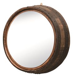 a round wooden mirror hanging on the wall next to a metal hook with an iron ring around it