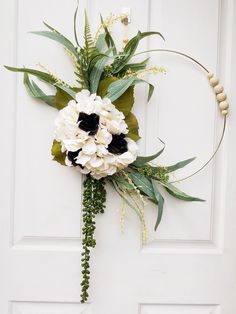 a white and black bouquet hanging on the front door