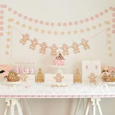 a dessert table with gingerbread cookies, cupcakes and other treats on it