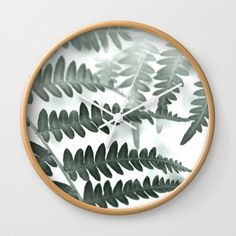 a clock with green leaves on it