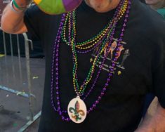 a man wearing beads and a mardi gras hat