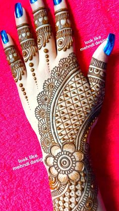 henna tattoo on the palm of someone's hand with blue nail polishes