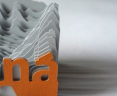 an orange and gray paper with the word ama on it's front end is shown